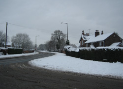 Junction of Moor Lane and Chester Road looking towards Moor Cottage and down Chester Road in Woodford, Cheshire taken by Ruth Jones