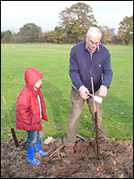 Mathew Horrocks planting a jubilee tree with his grandad Brian Horrocks a member of the Woodford Community Centre management committee
